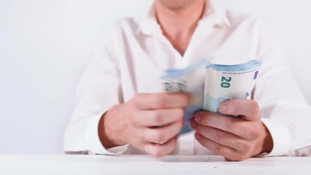Man's hands counting the bundle of euro 20 banknotes close up video