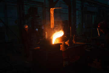 Fototapeta na wymiar Worker of foundry production. The burning metal