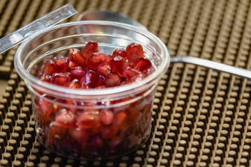 pomegranate seeds in plastic cup