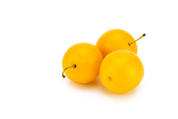 Three yellow cherry plums - isolated on white background