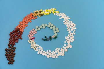 Multicolored pills and capsules in the form of a spiral.