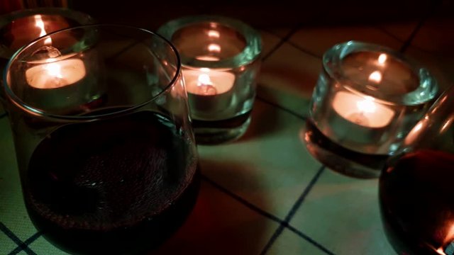red wine poured in casual unpretentious glasses, underprivileged couple enjoying the weekend in modest way