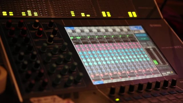 Professional audio Mixer and Professional Headphones in the Recording Studio. Sound Mixing Desk.