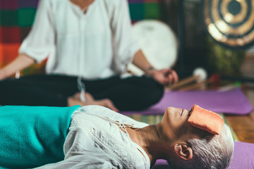 Senior woman on a guided meditation class