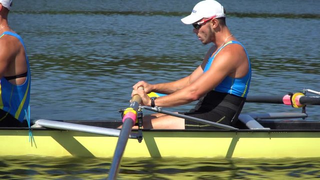 Rowing team summer training. 8 athletes rowers in a boat in the river Dnipro. City area in Kiev, Ukraine