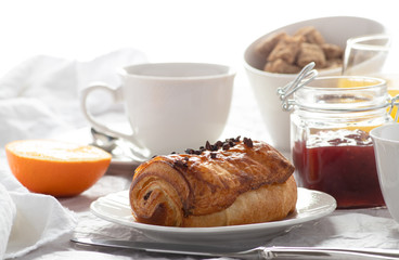 Continental breakfast served with fresh chocolate croissant, coffee, orange juice and jam.