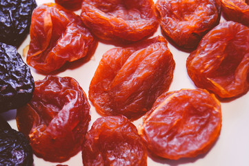 Dried apricot and dried plum - prunes on a white background. Healthy breakfast. Proper nutrition. Top view. Close up