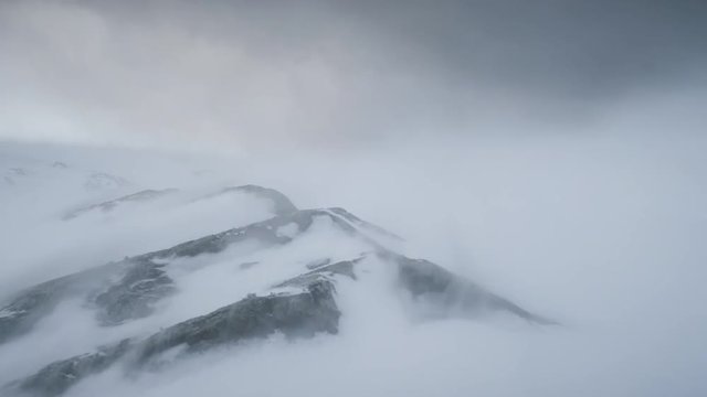 Blizzard Over Antarctica Mountains. Aerial Time Lapse Over South Pole. Harsh Wild Environment. Natural Polar Phenomena in Antarctic Midsummer. Winter Landscape In Grey White Tints. 4k Footage.