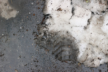 Melting snow asphalt slush water puddle flow dirty street sidewalk