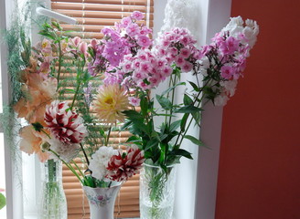 bouquets of flowers in a vase on the window