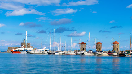 rhodes,greece old windmills in the port by the sea of aegean