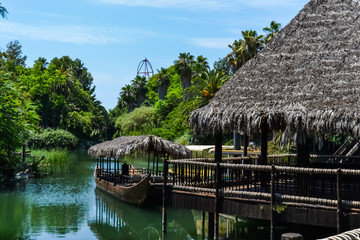 a real jungle in an amusement Park, nature trees ferns of the river and boats © GEMIMAGES