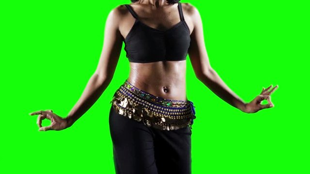 Slow motion of unrecognizable woman practicing a zumba dance in the studio with green screen background
