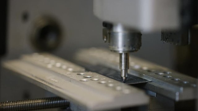 CNC diamond head engraver carving out text on a metallic surface