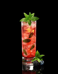 cold cocktail of blackberry and blueberry with mint on a black background