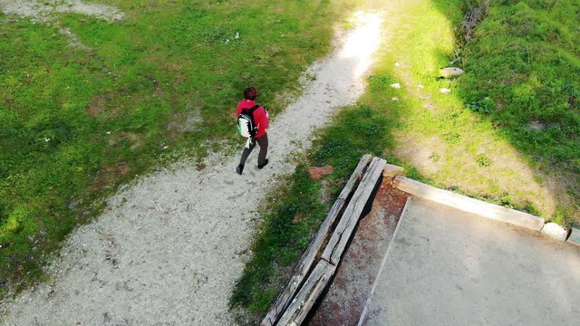 Man walking with the backpack.