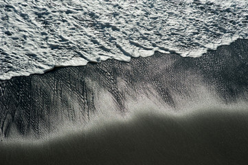sea wave on a black pebble like a iceland beach