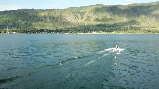 Drone view of jetski on lake Toba near Samosir Island, Sumatra, Indonesia.