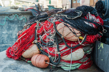 Fototapeta na wymiar Colorful fishing gear, tackle and nets in port