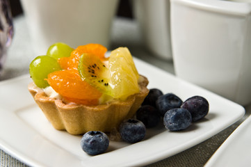 Fruit cake with coffee on the table