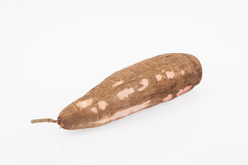 Raw yucca on white background-Manihot esculenta. (Cassava raw tuber)