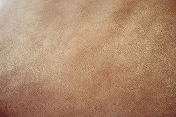 Elegant light brown leatherette background with vignetting. 