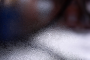 Water drops on glass window close up with blurred background. Drops in macro. Condensate on window closeup. Wet air.