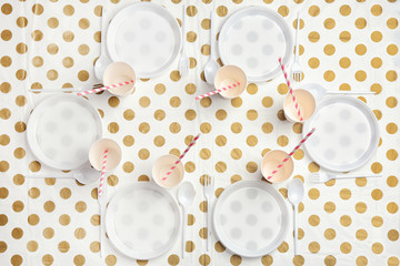 Table setting with plastic dishware on patterned background, top view