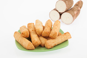 tasty fried yucca sticks on white background