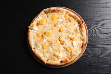 Hot cheese pizza Margherita on wooden table, top view