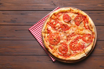 Hot cheese pizza Margherita on wooden table, top view. Space for text