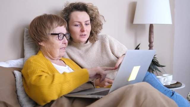 Young Woman And Elderly Woman Using Laptop Computer