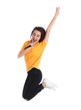 Young woman wearing casual clothes singing in microphone on white background