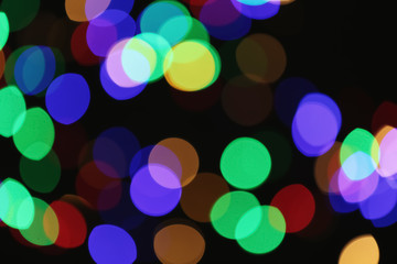Beautiful colorful lights on dark background. Bokeh effect