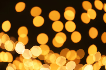 Beautiful golden lights on dark background. Bokeh effect