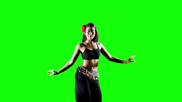 Pretty young woman dancing zumba in the studio. Shot in 4k resolution with green screen background