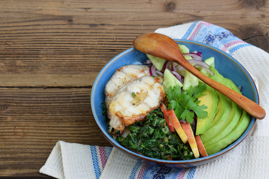 Stewed chard with apples, avocado, fish and salad of cucumbers, onions. AIP breakfast, dinner or lunch. Autoimmune Paleo. Diet healthy food concept. Cereals Gluten Dairy free. Buddha Bowl. Copy space.