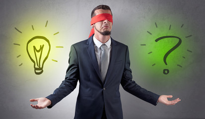 Covered eye businessman with bulb and question sign symbols around
