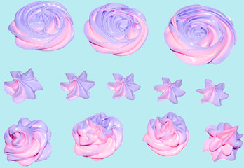 colored pink and marshmallow marshmallows in the shape of a flower for decorating a festive dessert on an isolated blue background