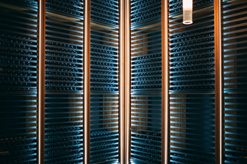 Wine bottles stored in a winery on the fermentation process