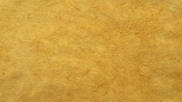 background of sunflower yellow handmade Huun paper created by Mayan artisans in Mexico from a tree bark - horizontal pan