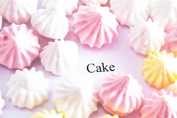 bright colored cakes on a white background, next to the sweets