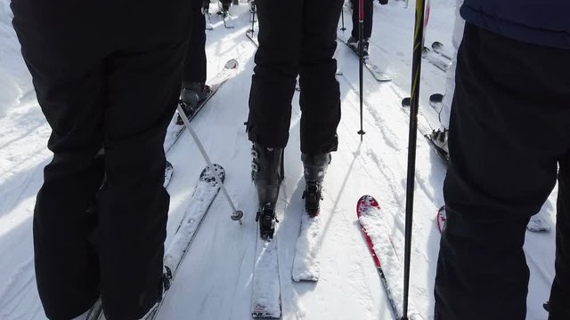 ROGLA, SLOVENIA, 2019.01.29: People waiting and slowly moving towards ski lift. Mountain ski resort with daughter on cold sunny winter day.