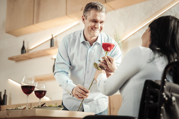 Disabled woman taking a flower from man