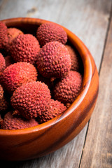 Red ripe lychees on the rustic background. Selective focus. Shallow depth of field.