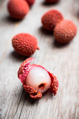 Red ripe lychees on the rustic background. Selective focus. Shallow depth of field.