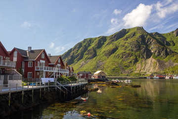 Fototapeta na wymiar colorful houses and harbor at the foot of the mountains in Lofoten