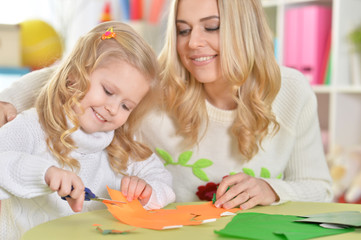 Mother teaches kid to do craft items