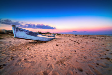 Fishing boat on the evening beach. Hammamet, Tunis.