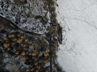 aerial view with a drone of a snowy road in germany
